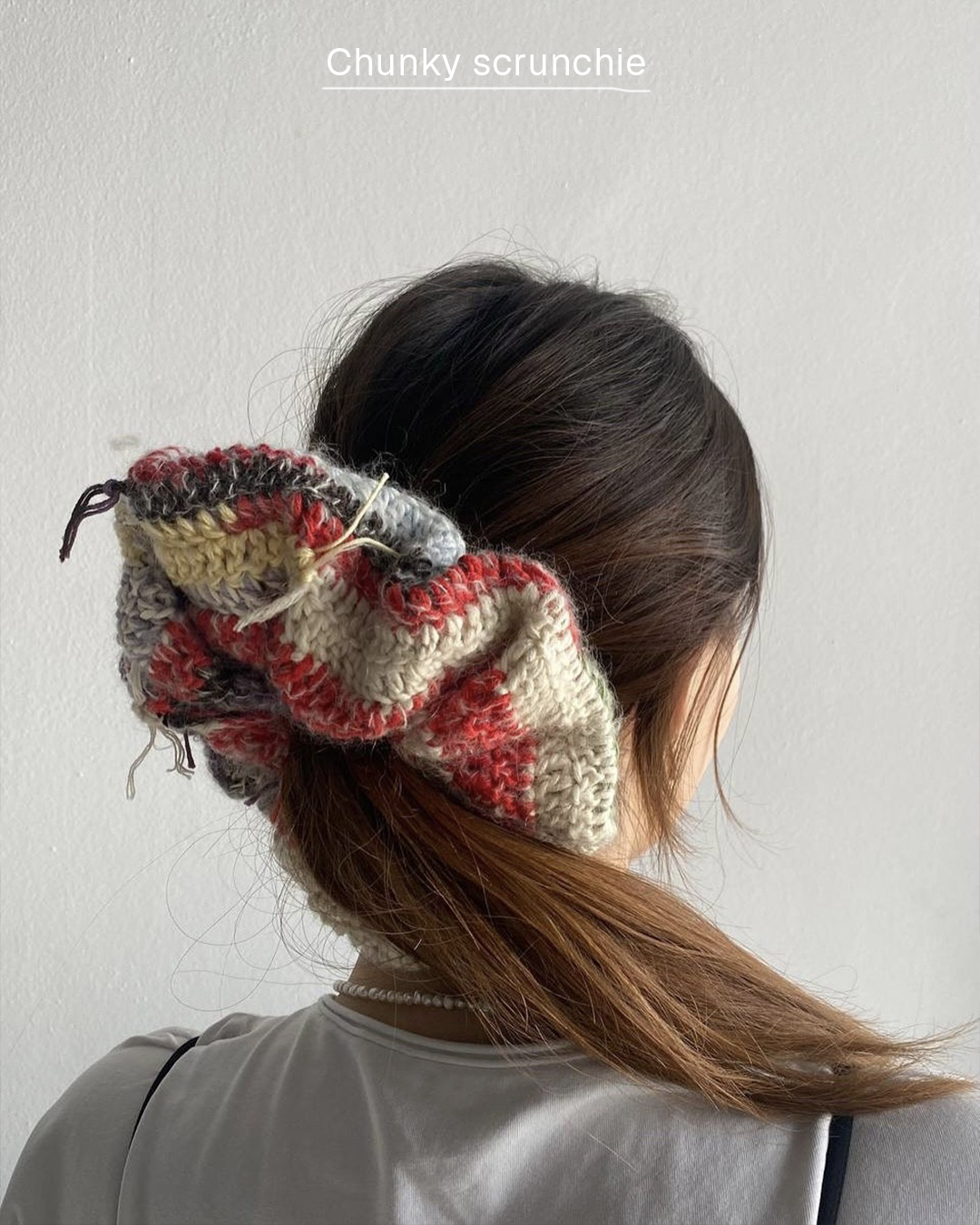Multicolored chunky crochet scrunchie tied in a ponytail